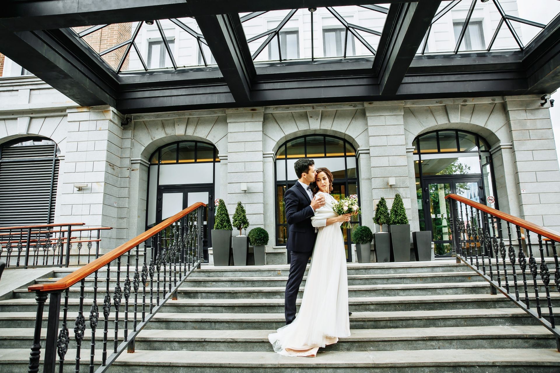 Bride and groom walking around among the houses and buildings